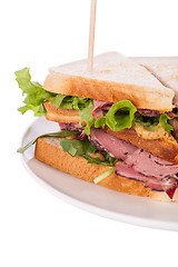 Image showing Delicious pastrami club sandwich and pickles