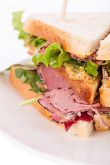 Image showing Delicious pastrami club sandwich and pickles