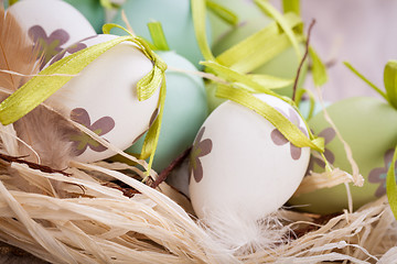 Image showing Colourful green Easter eggs in straw