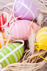 Image showing colorful easter egg decoration on wooden background