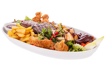 Image showing Platter of mixed meats, salad and French fries