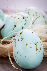 Image showing Three natural blue Easter eggs in a basket