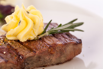 Image showing Grilled beef steak topped with butter and rosemary