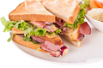 Image showing Delicious pastrami club sandwich and pickles