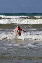 Image showing The woman in the sea against big waves.