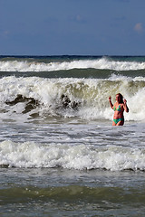 Image showing The woman in the sea against big waves.