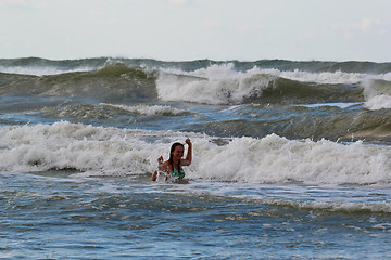 Image showing The woman in the sea against big waves.