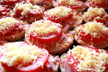 Image showing hot sandwiches with sausage and melted cheese