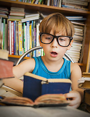 Image showing boy reading book while preparing for lesson