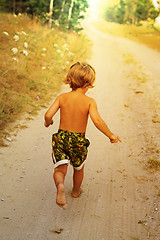 Image showing Boy running along road in park, outdoor