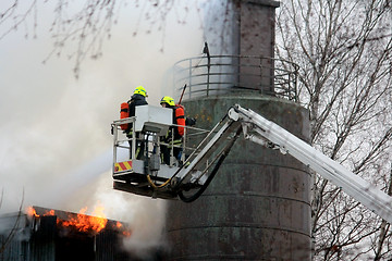 Image showing Firefighters Extinguishing Fire on Hydraulic Crane Platform