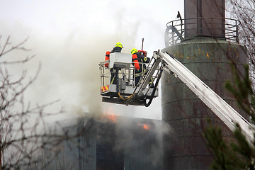 Image showing Firefighters Extinguishing Fire on Hydraulic Crane Platform