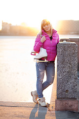 Image showing Blond woman standing with ice skates