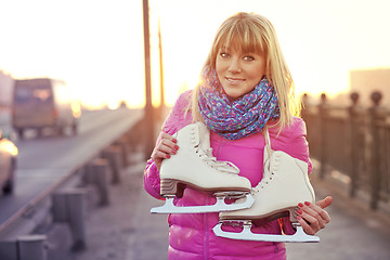 Image showing Beautiful smiling blond woman with ice skates