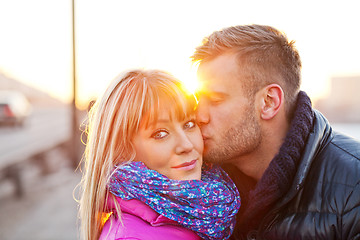 Image showing Young man kissing a beautiful woman