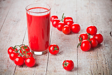 Image showing tomato juice in glass and fresh tomatoes