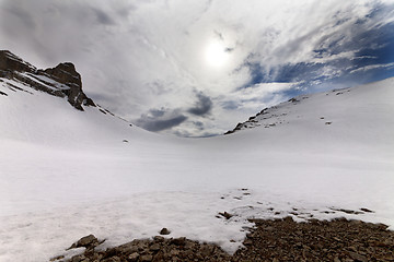 Image showing Snowy mountain pass and sky with clouds at evening