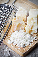 Image showing grated parmesan cheese and metal grater 
