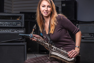 Image showing Pretty woman with saxophone
