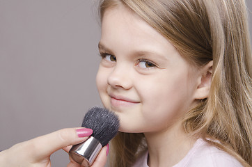 Image showing Makeup artist deals powder on face of girl