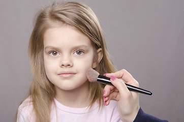 Image showing Makeup artist deals powder on face of girl