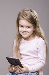 Image showing Portrait girl with a small mirror in hands of