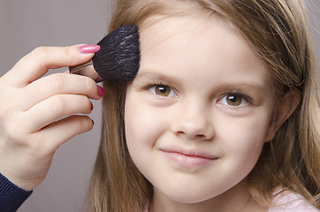 Image showing Makeup artist deals powder on face of girl