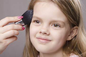 Image showing Makeup artist deals powder on face of girl