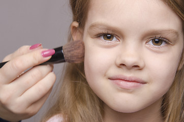 Image showing Makeup artist deals powder on face of girl