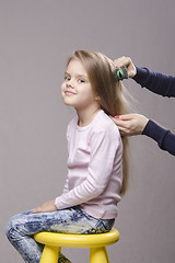 Image showing Hairdresser brushing her long hair girls