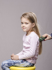 Image showing Hairdresser brushing her long hair girls