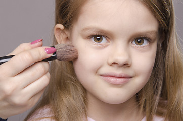 Image showing Makeup artist deals powder on face of girl