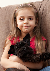 Image showing Girl with puppy