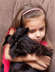 Image showing Miniature schnauzer and little girl