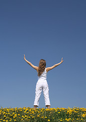 Image showing Young woman exercising in dandelion field