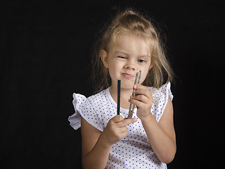 Image showing Disheveled girl looks at compass