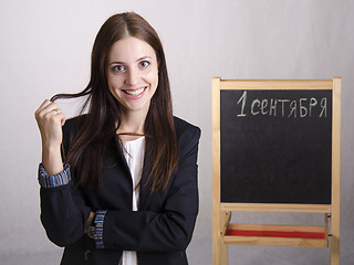 Image showing Portrait of teacher in a great mood and Board