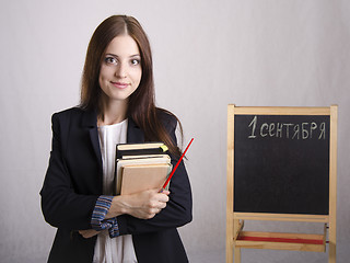 Image showing Portrait of the teacher with textbooks and Board