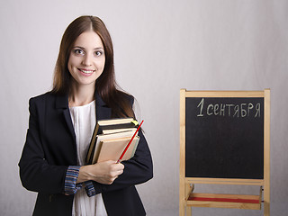 Image showing Portrait of the teacher with textbooks and Board