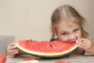 Image showing Two-year-old girl eating watermelon with cheerful faces