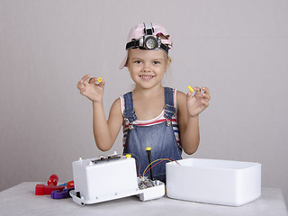 Image showing Girl playing monter holds the screw and nut