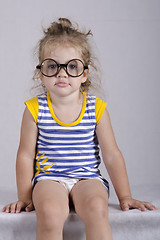 Image showing Two-year-old girl funny glasses sitting looking in frame