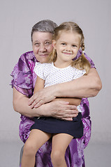 Image showing Portrait of an elderly woman covering her granddaughter