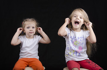 Image showing Portrait of sisters, and two little girls, have joined hands behind ears