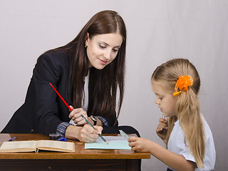 Image showing teacher teaches lessons with student sitting at table