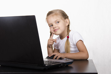 Image showing girl sitting in table, working at laptop