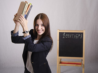 Image showing Master cheerfully raised over head of textbooks