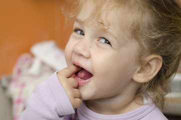 Image showing little girl with enthusiasm and eats roll pleasure