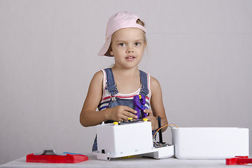 Image showing Girl repairs toy small home appliances