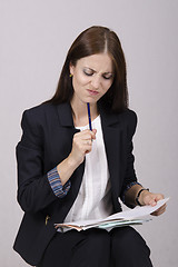 Image showing School teacher checks notebooks students with homework